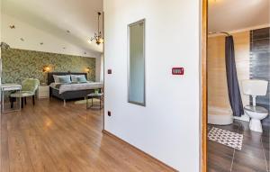 a room with a bed and a living room at Lovely Home In Loborika in Loborika