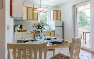 a kitchen with a table and chairs and a dining room at Amazing Apartment In Medulin With Kitchen in Medulin