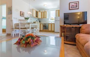 a living room with a glass coffee table and a kitchen at Apartment Brajdine 75,App Vi in Medulin