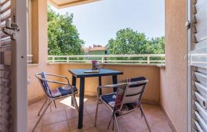 a patio with two chairs and a table on a balcony at Apartment Brajdine 75,App Vi in Medulin +20 photos