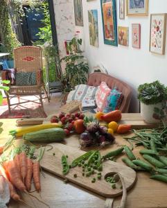 a table topped with lots of vegetables on a table at Maison Léontine in Bernay