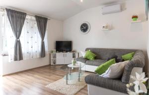a living room with a couch and a table at Stunning Apartment In Pavicini With Wifi in Pavicini