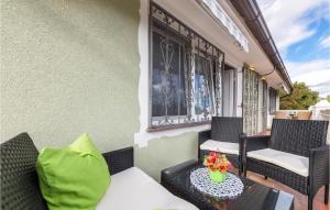 a balcony with chairs and a table with flowers on it at Lovely Apartment In Pavicini With Wifi in Pavicini +14 photos