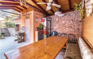 a wooden table and chairs on a patio at Gorgeous Apartment In Volosko With Kitchen in Volosko
