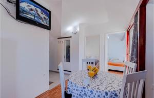 a dining room with a table and chairs and a television at Beautiful Apartment In Vela Luka With Wifi in Vela Luka