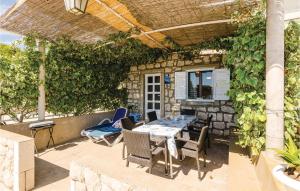 a patio with a table and chairs under a pergola at Apartment Banici Ii in Slano +23 photos