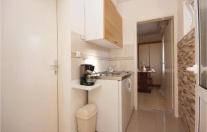 eine kleine weiße Küche mit einem Waschbecken und einem WC in der Unterkunft Apartment Raslina Lxvii in Raslina