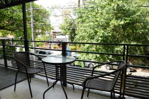 a table and chairs on a balcony with a view at Hotel Nakama in Medellín +30 photos