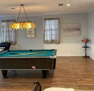 a living room with a pool table and a lamp at Welcome to Columbia!-enjoy this tranquil space in Columbia