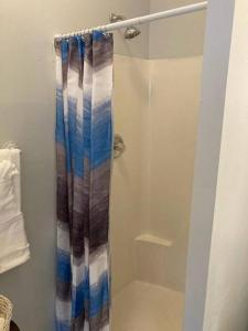 a shower with a shower curtain in a bathroom at Welcome to Columbia!-enjoy this tranquil space in Columbia