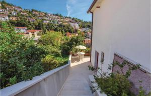 a balcony of a building with a view of a city at Lovely Apartment In Rabac With Kitchen in Rabac +19 photos