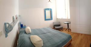 a hospital room with a bed and a chair at Apartment Old Town Design in Rab