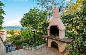 a outdoor pizza oven sitting on top of a patio at 2 Bedroom Gorgeous Apartment In Njivice in Njivice