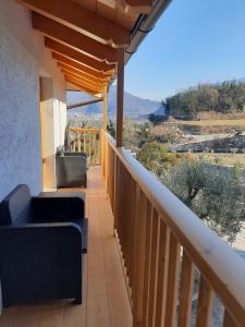 a balcony with chairs and a view of the desert at Appartamenti Piccolo Borgo in Arco