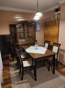 a dining room with a table and chairs at Mátyás Apartman in Tata