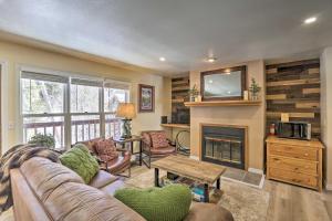 een woonkamer met een bank en een open haard bij Walk to Marina Rustic Grand Lake Retreat! in Grand Lake