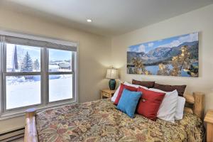 een slaapkamer met een bed en een groot raam bij Walk to Marina Rustic Grand Lake Retreat! in Grand Lake