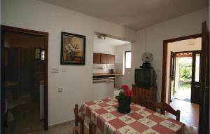 a dining room with a table and a tv at Awesome Apartment In Labin With Wifi in Raša