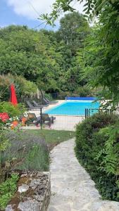 a view of a swimming pool in a garden at Uniquely Private Holiday Villa in the Charente in Puyréaux