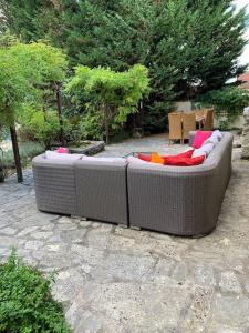 two wicker couches sitting on a stone patio at Uniquely Private Holiday Villa in the Charente in Puyréaux