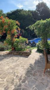 a bench sitting on the sand in a garden at Uniquely Private Holiday Villa in the Charente in Puyréaux