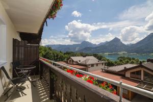 a balcony with a view of a lake and mountains at Pension Rudolfshöhe in St. Wolfgang