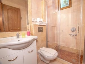 a bathroom with a toilet and a sink and a shower at Apartments and Rooms Levantin Inn in Sveti Stefan