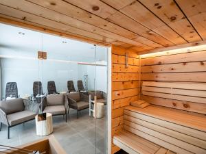 a sauna with chairs and tables in a room at Chalet in Saalbach near Ski Lift in Saalbach-Hinterglemm