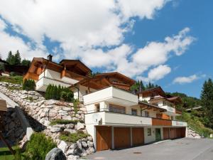 a house on a hill with a garage at Chalet apartment in Saalbach Hinterglemm in Saalbach-Hinterglemm