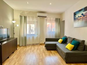 sala de estar con sofá y TV de pantalla plana en Comfortable renovated flat, WiFi!, en Badalona