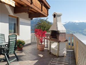 a patio with a bird house on a balcony at Lovely Apartment with Terrace in F genberg in Fügen