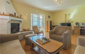 a living room with a chess board on a coffee table at Stunning Home In Jezera With 2 Bedrooms, Wifi And Outdoor Swimming Pool in Jezera