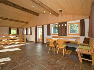 a large living room with a table and chairs at Chalet in Hopfgarten in Brixental with hot tub in Hopfgarten im Brixental