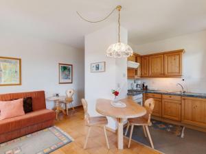 a kitchen and living room with a table and a couch at Apartment in Afritz near Ski Slopes in Afritz