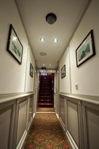 a hallway with two staircases and a painting on the wall at Kapitein Anna in Amsterdam