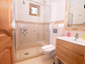 a bathroom with a shower and a toilet and a sink at Apartments and Rooms Levantin Inn in Sveti Stefan