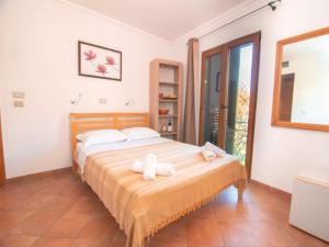 a bedroom with a bed with two towels on it at Apartments and Rooms Levantin Inn in Sveti Stefan