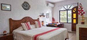 Un pat sau paturi într-o cameră la Maison Tulum