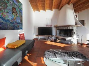 a living room with a couch and a fireplace at Avalon in Brissago