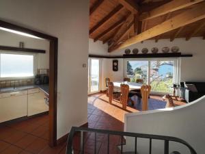 a kitchen and dining room with a table and chairs at Avalon in Brissago