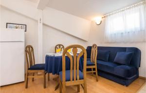 a living room with a table and a blue couch at Holiday Apartment Privlaka 06 in Privlaka