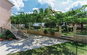 a staircase in a yard with a brick wall at 2 Bedroom Amazing Apartment In Kanfanar in Kanfanar +22 photos