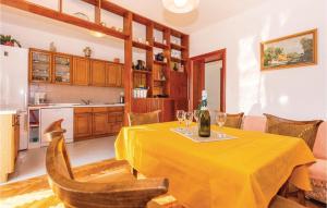 a dining room with a table with a bottle of wine at Nice Apartment In Bribir With 3 Bedrooms And Wifi in Bribir