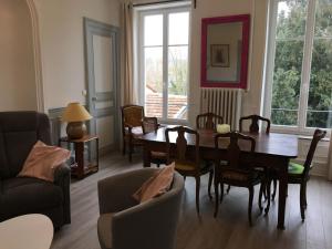 uma sala de estar com uma mesa de jantar e cadeiras em Gîte Saint-Nicolas-de-Port, 4 pièces, 6 personnes - FR-1-584-179 em Saint-Nicolas-de-Port