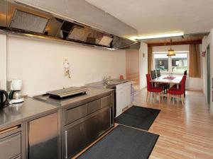 a kitchen with a sink and a table with chairs at Spacious Holiday Home in Wenns near Ski Area in Wenns