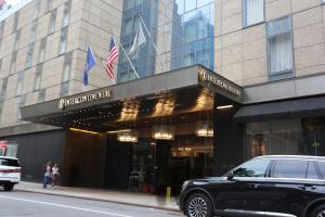 a black car parked in front of a building at InterContinental New York Times Square by IHG in New York