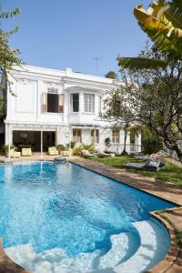 a swimming pool in front of a house at Mama Ruisa Boutique Hotel in Rio de Janeiro