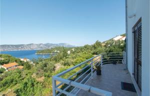 a balcony of a house with a view of the water at Lovely Apartment In Racisce With House A Panoramic View in Račišće