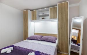 a small bedroom with a bed and a mirror at Gorgeous Apartment In Pavicini With Kitchen in Pavicini
