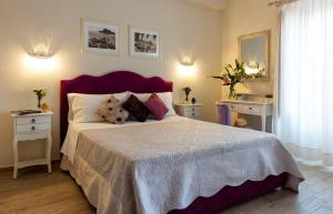 a bedroom with a large bed and two night stands at Valentina in Taormina